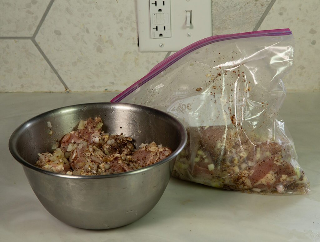 Place the meat and onions in a plastic bag or bowl.