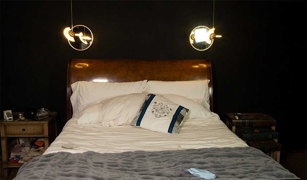 Bedroom with round mirrors hanging on the focal wall.